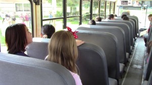 Students follow Points of Pride while riding the bus.